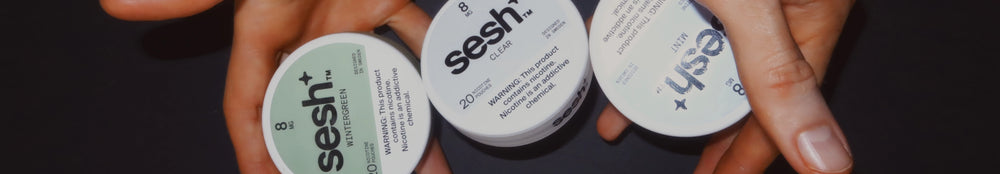 Three cans of sesh+ 8mg nicotine pouches in Wintergreen, Clear, and Mint flavors held in hands